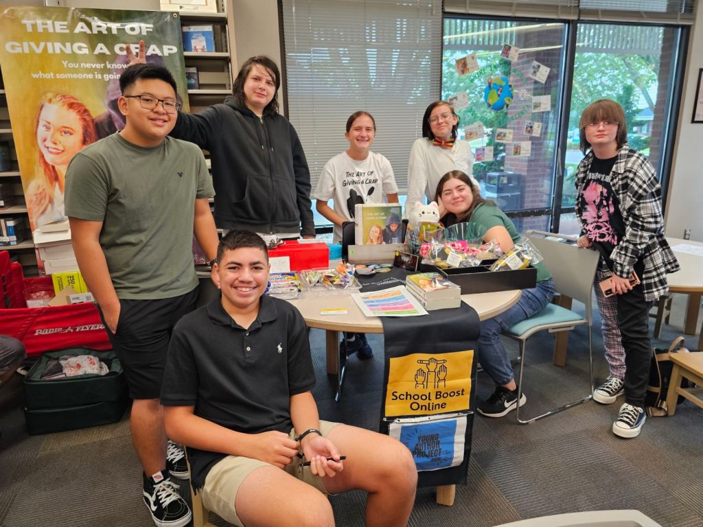 Our team of young authors pose for a picture at their first official book signing for "The Art of Giving A Crap" at the Mount Pleasant Public Library